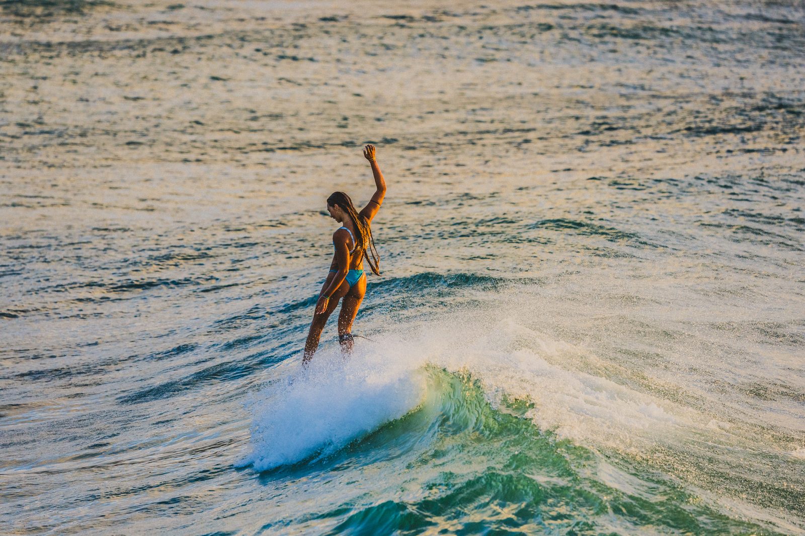 A surfer gliding across the wave